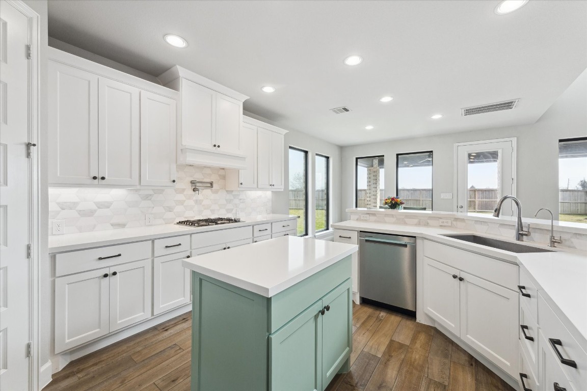 9951 Chapman Trail Manvel, TX 77578 - Photo 16 of 50 a kitchen with a sink stove cabinets and refrigerator