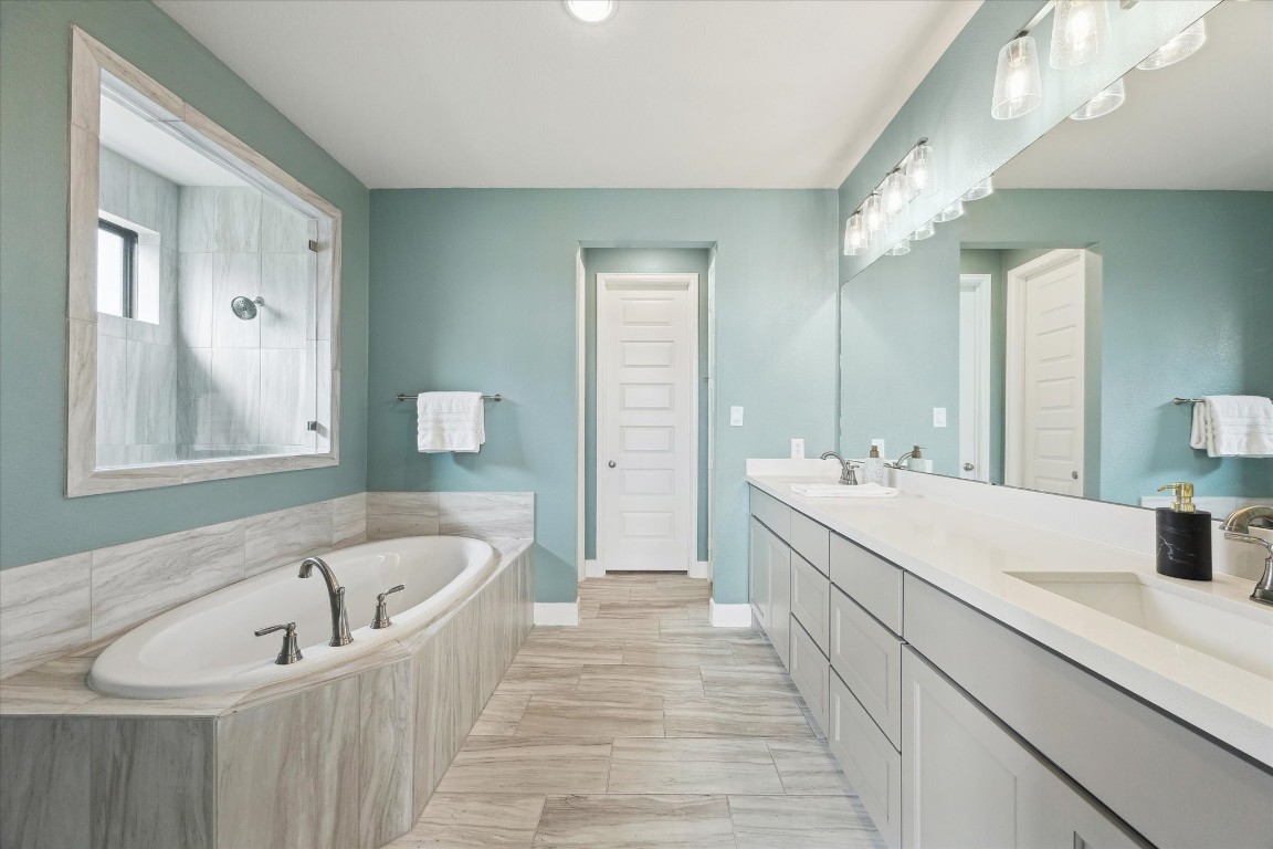 9951 Chapman Trail Manvel, TX 77578 - Photo 21 of 50 a spacious bathroom with a tub sink and mirror