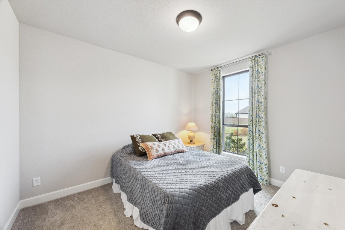 9951 Chapman Trail Manvel, TX 77578 - Photo 26 of 50 a bedroom with a bed and window