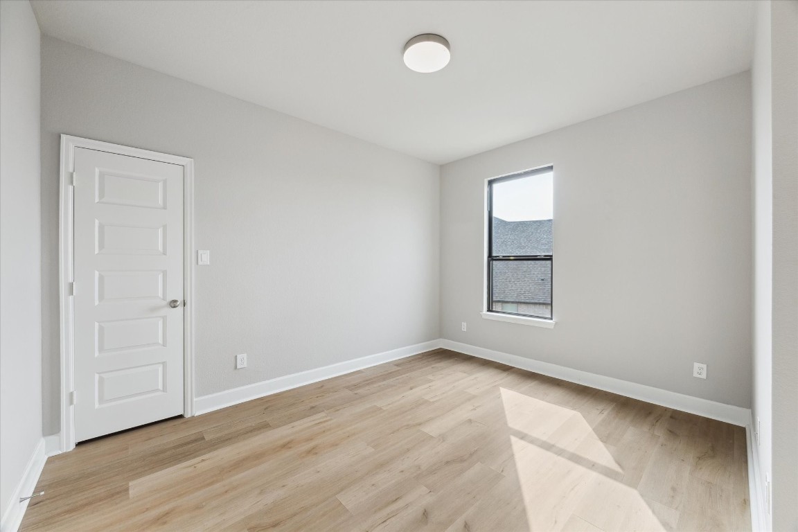 9951 Chapman Trail Manvel, TX 77578 - Photo 35 of 50 an empty room with wooden floor and windows