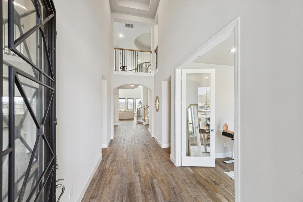 9951 Chapman Trail Manvel, TX 77578 - Photo 5 of 50 a view of a hallway with wooden floor and staircase