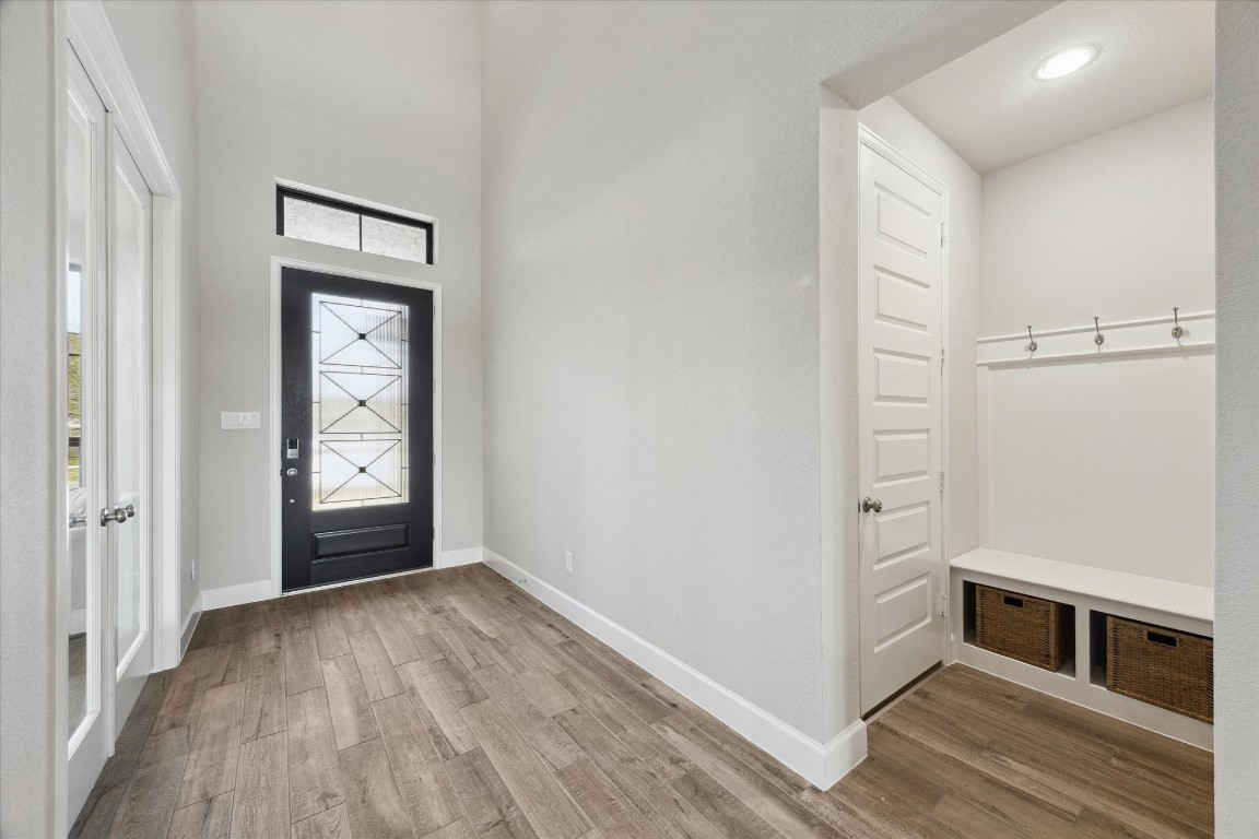 9951 Chapman Trail Manvel, TX 77578 - Photo 6 of 50 a view of an empty room with window and wooden floor