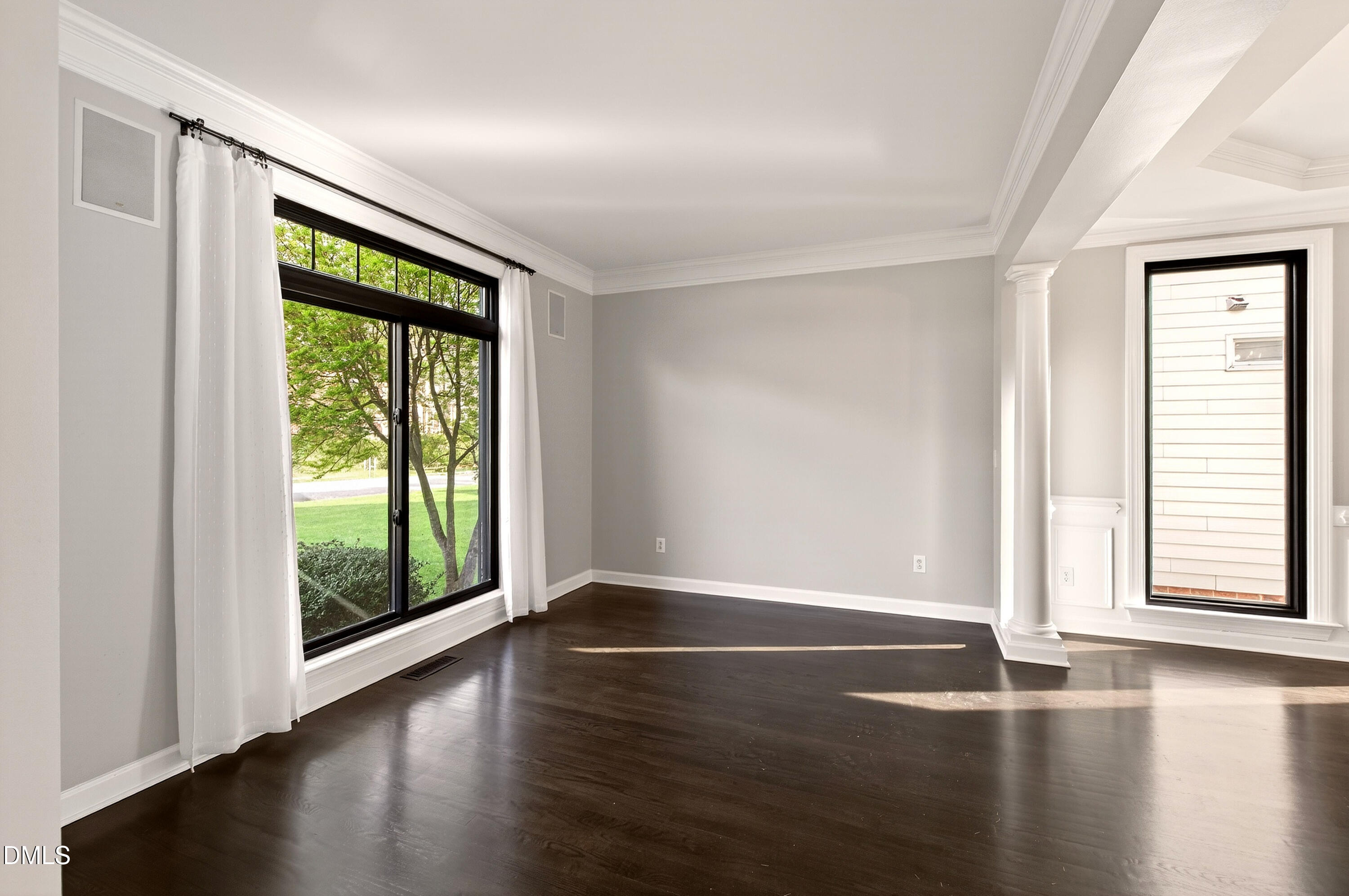 12408 Cilcain Court Raleigh, NC 27614 - Photo 10 of 80 a view of an empty room with wooden floor and a window
