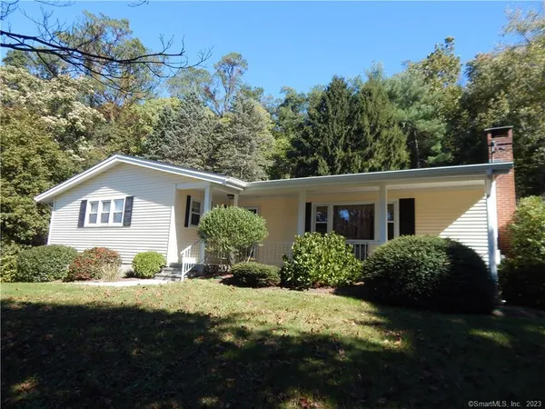 a view of house with yard and green space