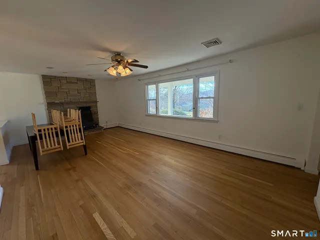 wooden floor in an empty room with a window