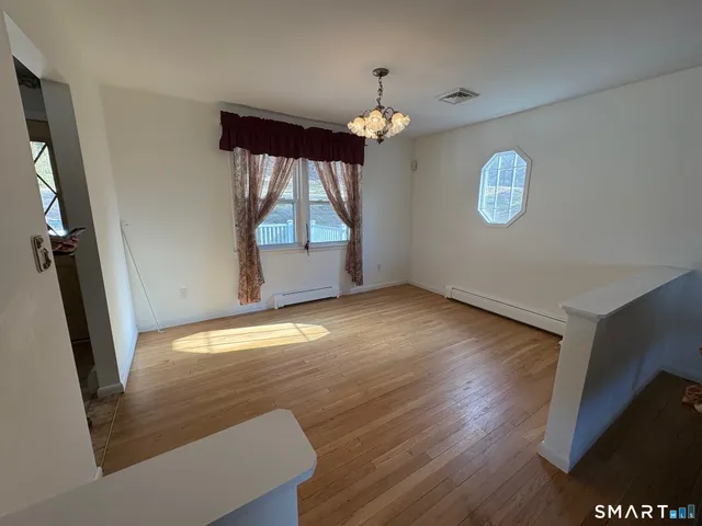 a large bathroom with a large mirror vanity and a shower