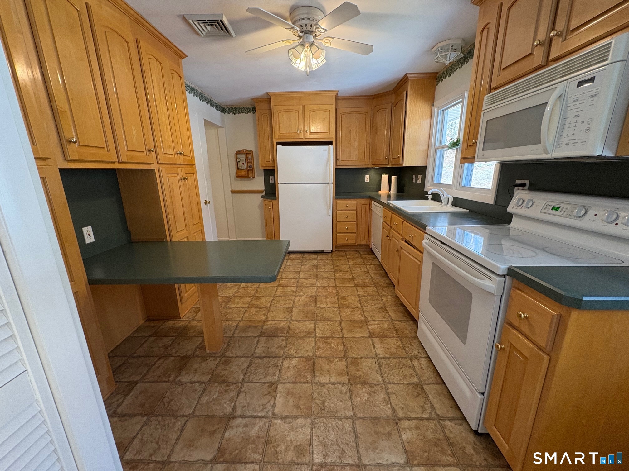 967 Derby-Milford Road Orange, CT 06477 - Photo 14 of 24 a kitchen with stainless steel appliances granite countertop a refrigerator a stove top oven a sink and dishwasher
