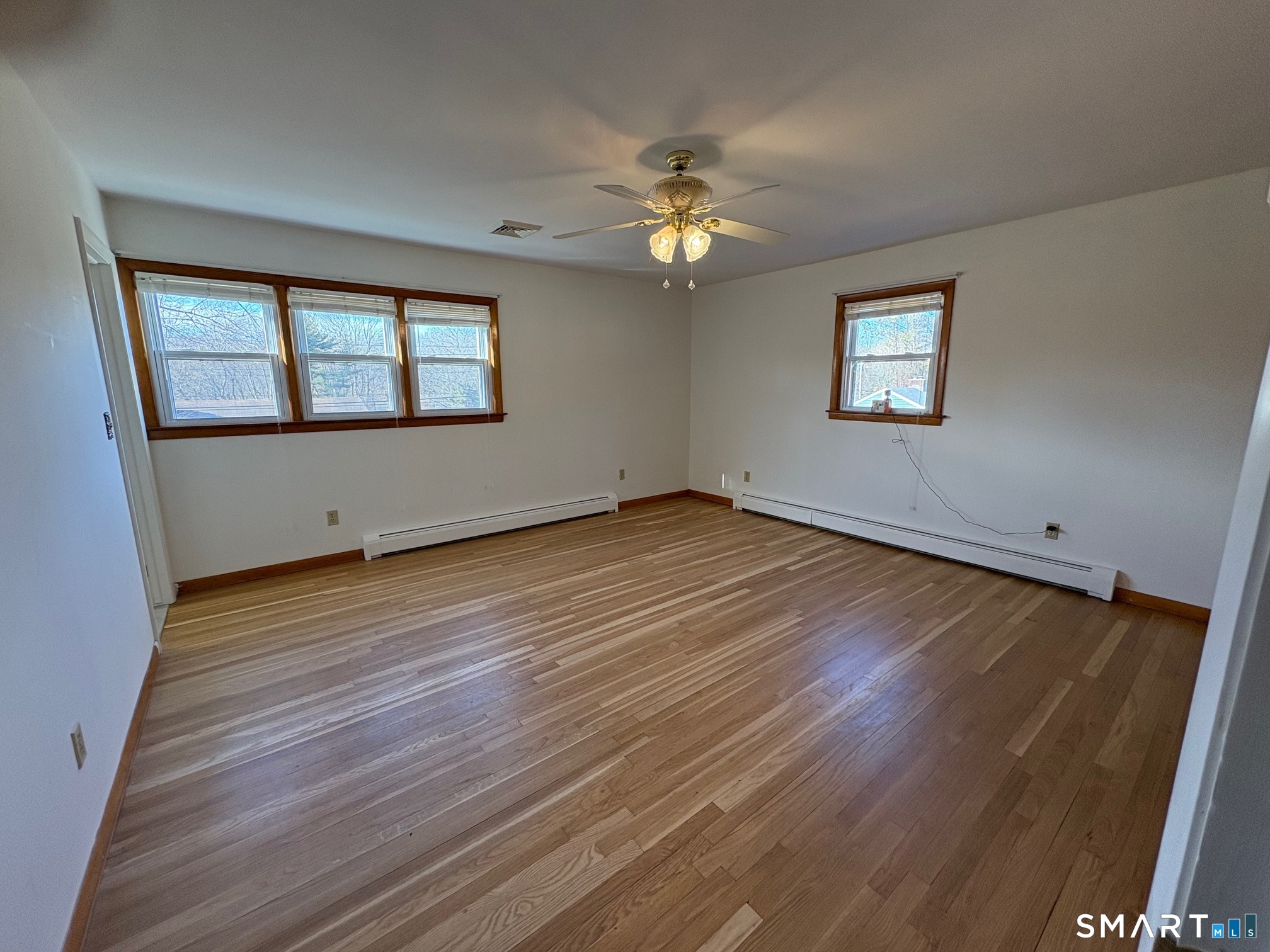 967 Derby-Milford Road Orange, CT 06477 - Photo 16 of 24 a view of an empty room with wooden floor and a window