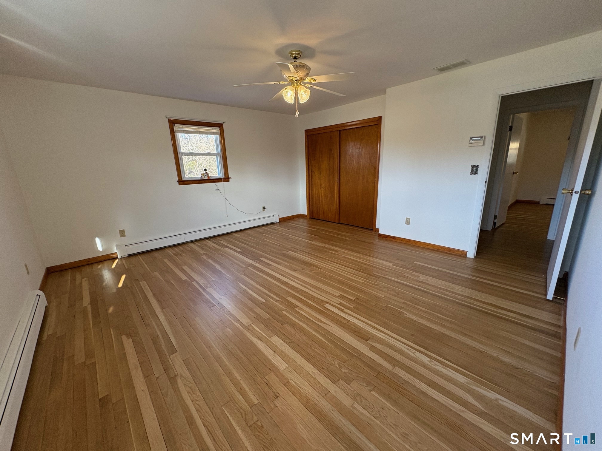 967 Derby-Milford Road Orange, CT 06477 - Photo 17 of 24 a view of an empty room with wooden floor and a ceiling fan