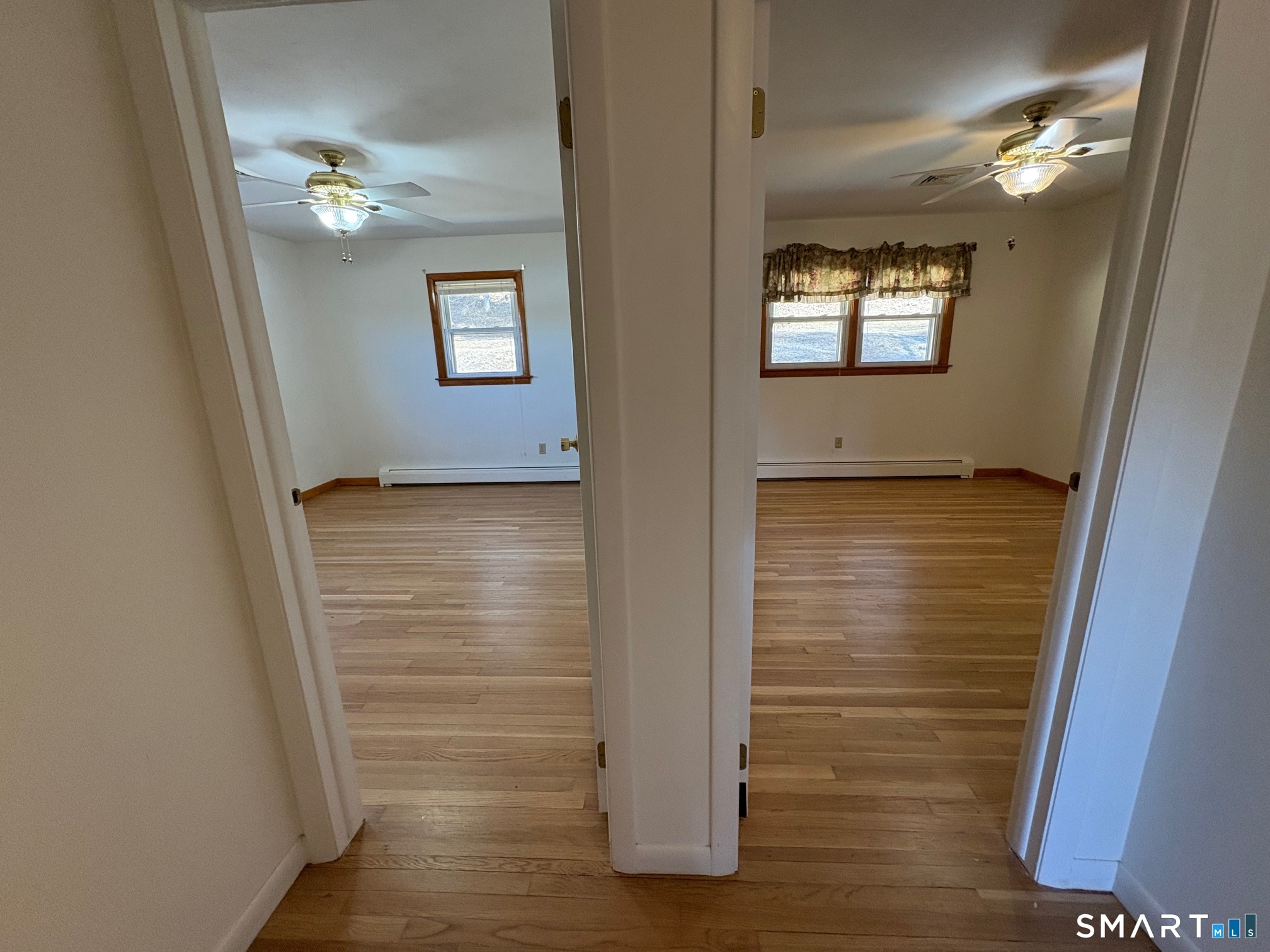 967 Derby-Milford Road Orange, CT 06477 - Photo 21 of 24 a view of an empty room with wooden floor and a window