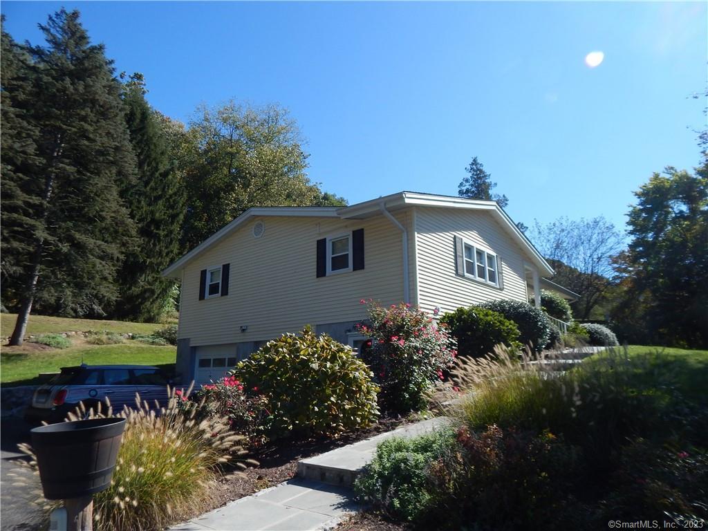 967 Derby-Milford Road Orange, CT 06477 - Photo 3 of 24 a view of a house with a yard and potted plants