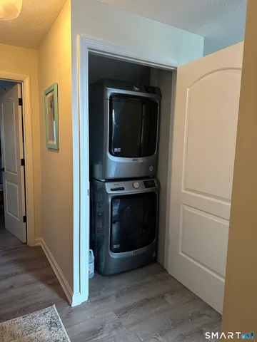 a living room with a door and a hallway