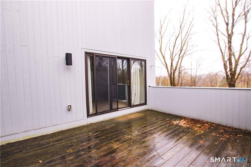 10 Sugar Maple Lane, Unit 10 Ridgefield, CT 06877 - Photo 13 of 13 a view of an empty room with wooden floor and a window