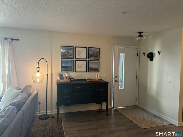 a room with a refrigerator and dresser