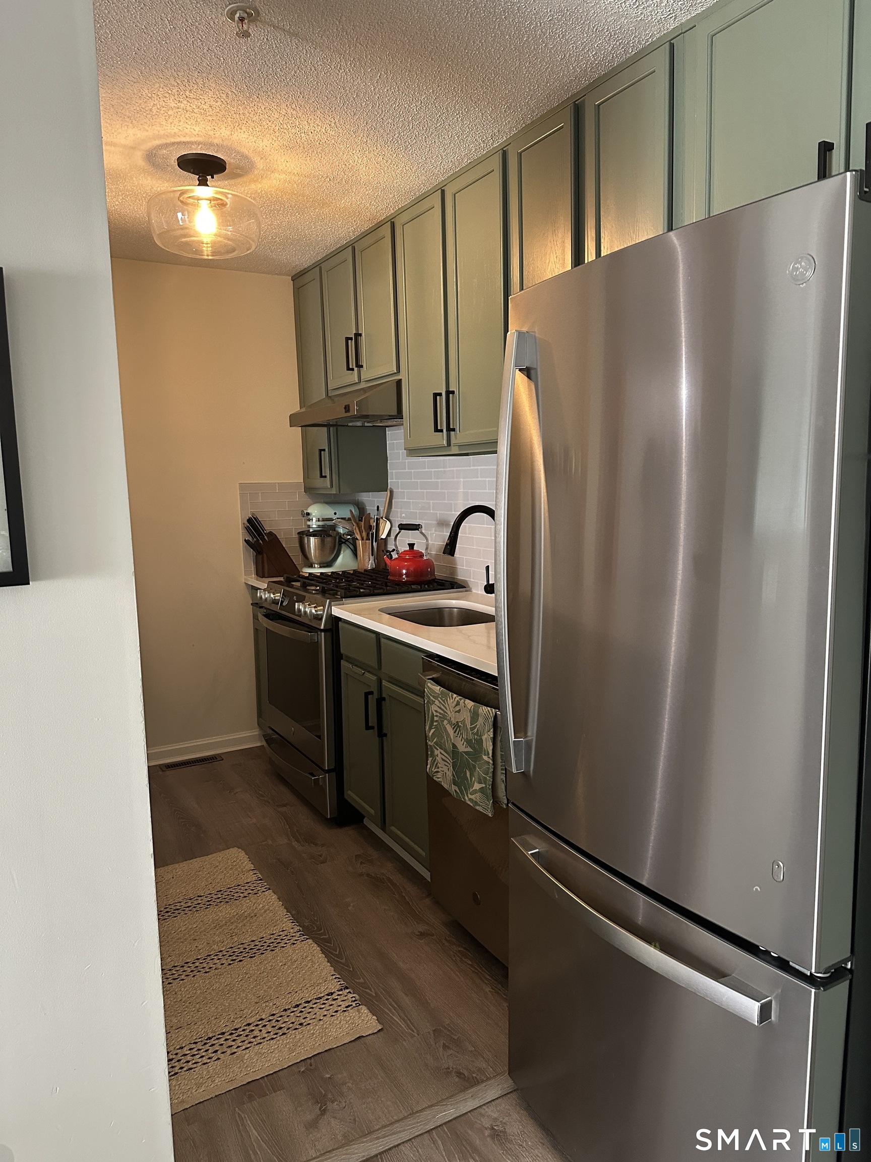 10 Sugar Maple Lane, Unit 10 Ridgefield, CT 06877 - Photo 6 of 13 a kitchen with stainless steel appliances a refrigerator and a sink