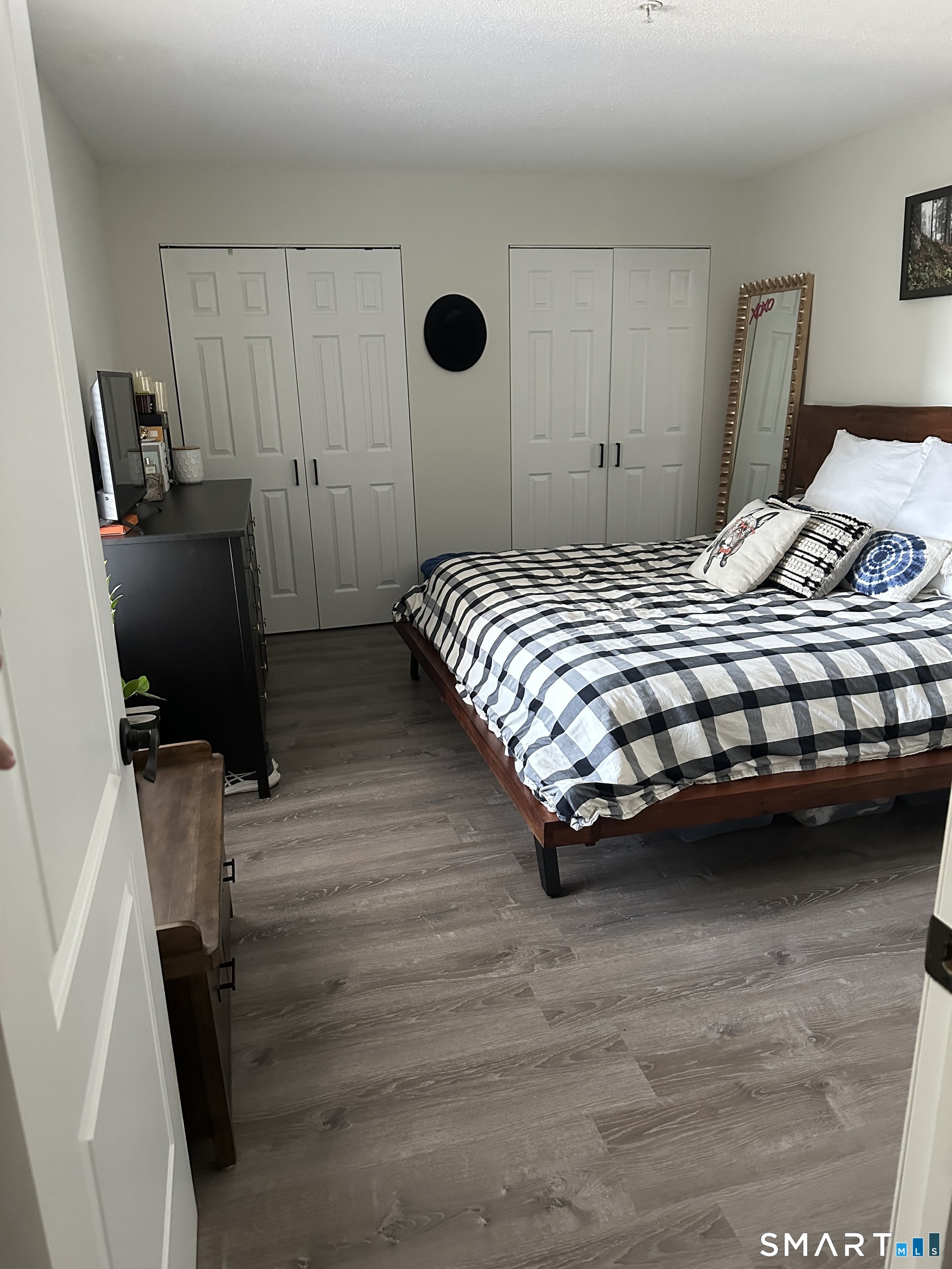 10 Sugar Maple Lane, Unit 10 Ridgefield, CT 06877 - Photo 8 of 13 a bedroom with a bed and wooden floor