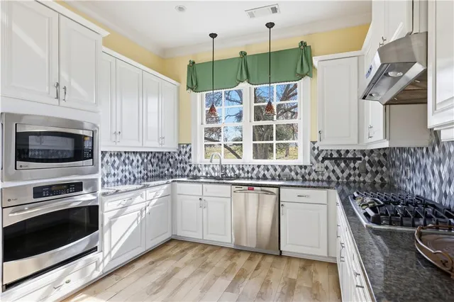 a kitchen with a sink stove and microwave