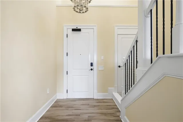a view of a hallway with wooden floor