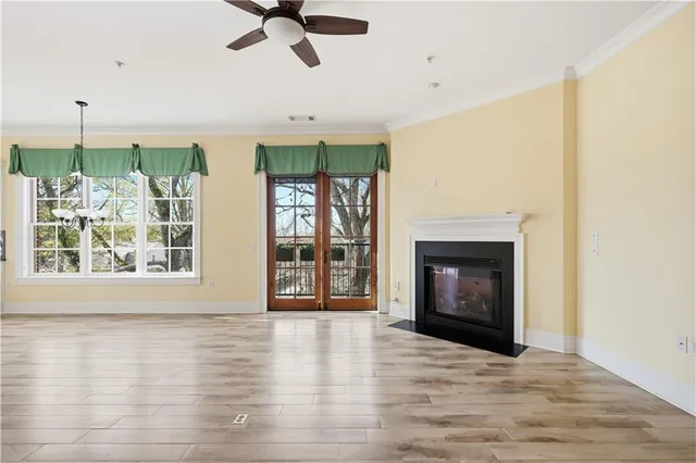 a view of an empty room with a window and fireplace