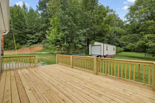 a view of balcony with deck and a garden