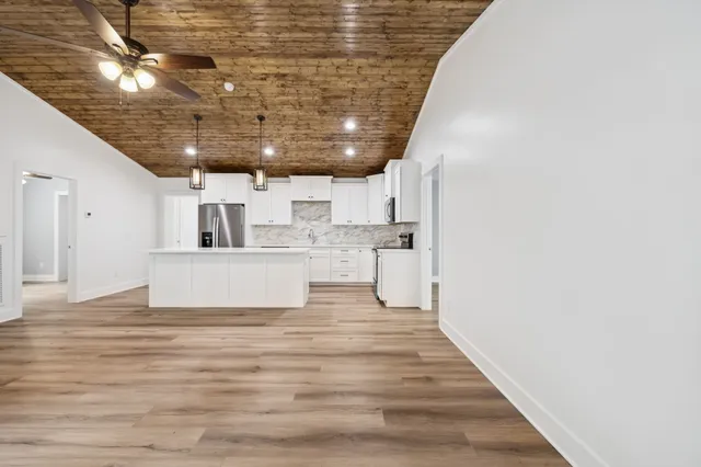 a view of a kitchen with a sink and cabinets