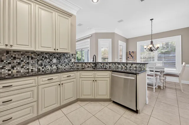 a kitchen with white cabinets sink and stainless steel appliances