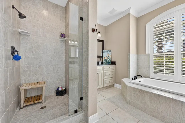 a living room with furniture and floor to ceiling windows