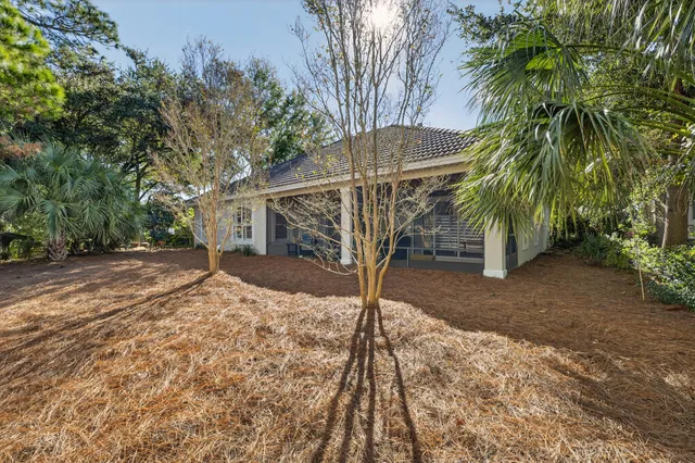 a living room with furniture a wooden floor and a large window