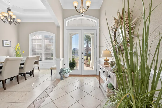 a dining room filled with furniture and a chandelier