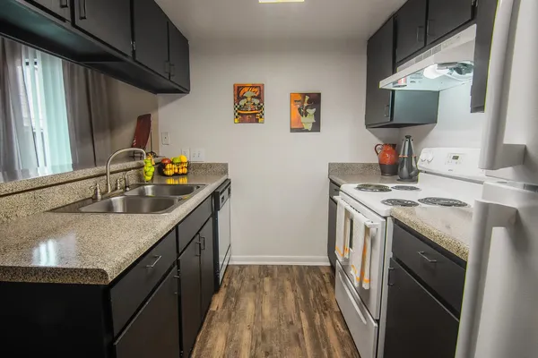 a kitchen that has a sink and a stove in it
