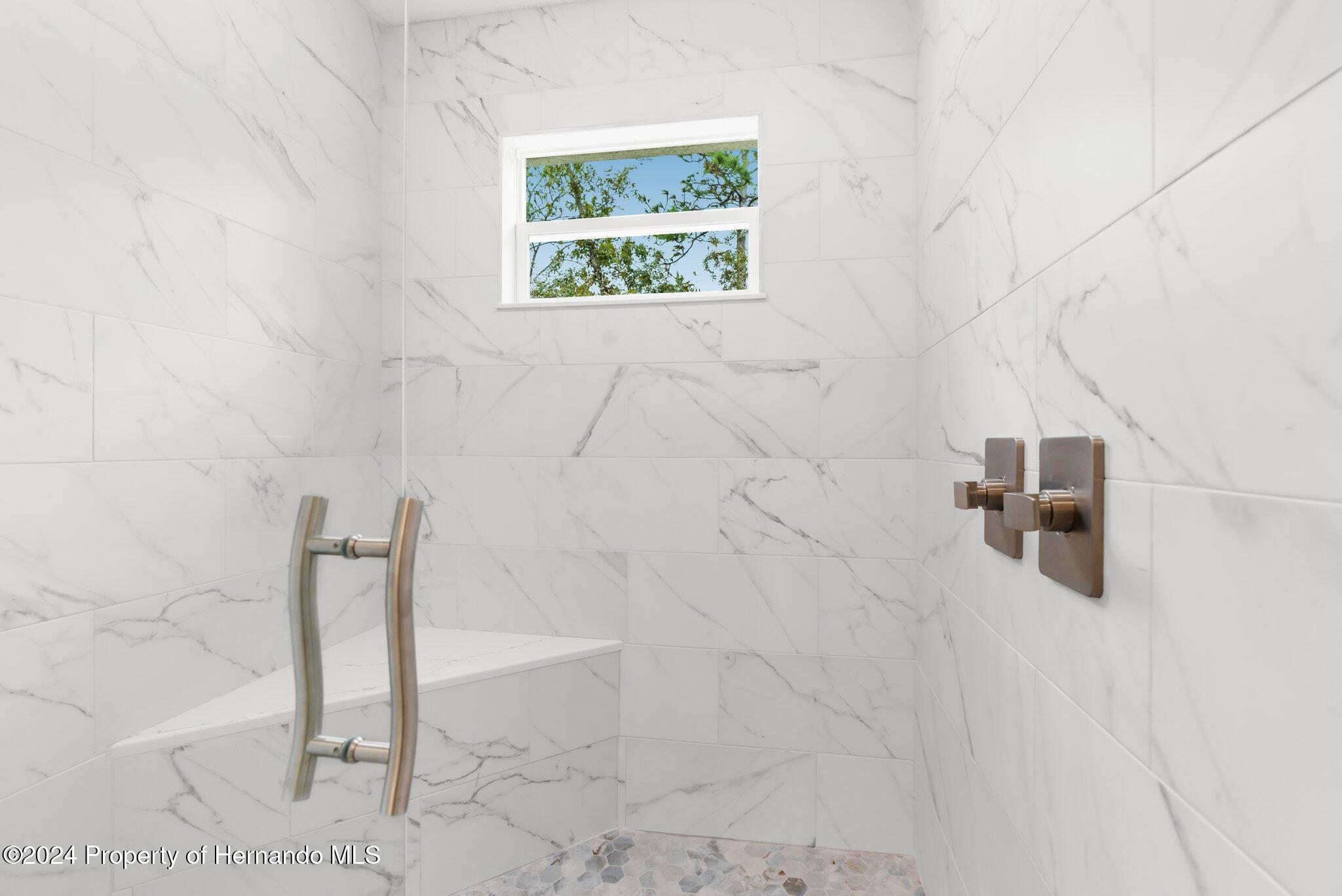 15214 Mt Sparrow Road Brooksville, FL 34614 - Photo 11 of 36 a bathroom with a shower