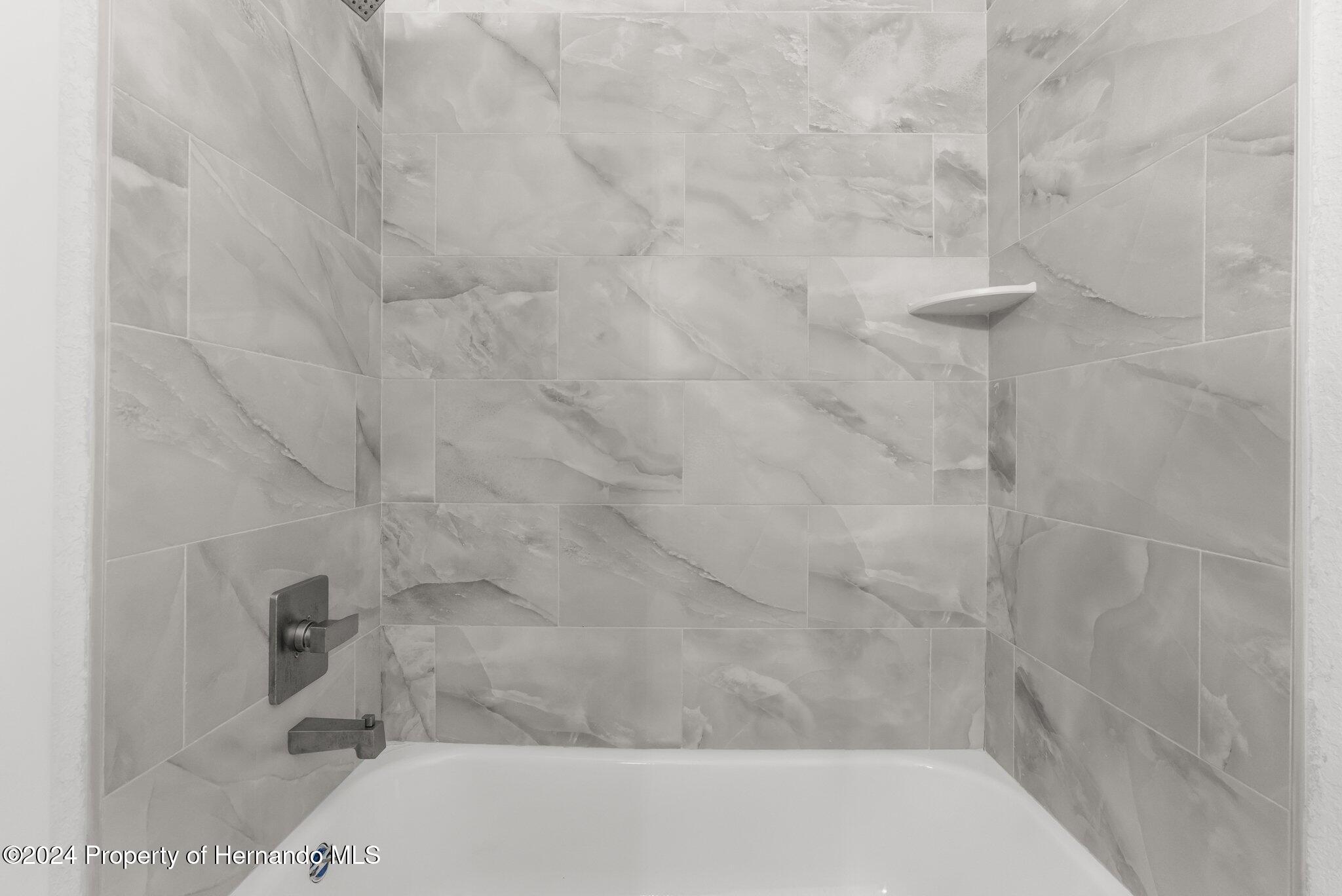 15214 Mt Sparrow Road Brooksville, FL 34614 - Photo 13 of 36 a bathroom with a bathtub