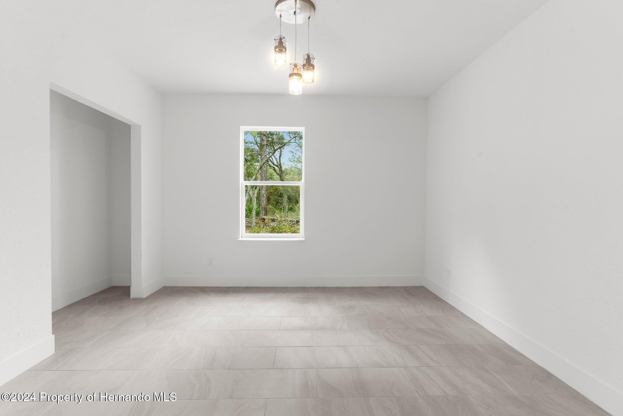 15214 Mt Sparrow Road Brooksville, FL 34614 - Photo 23 of 36 an empty room with a window