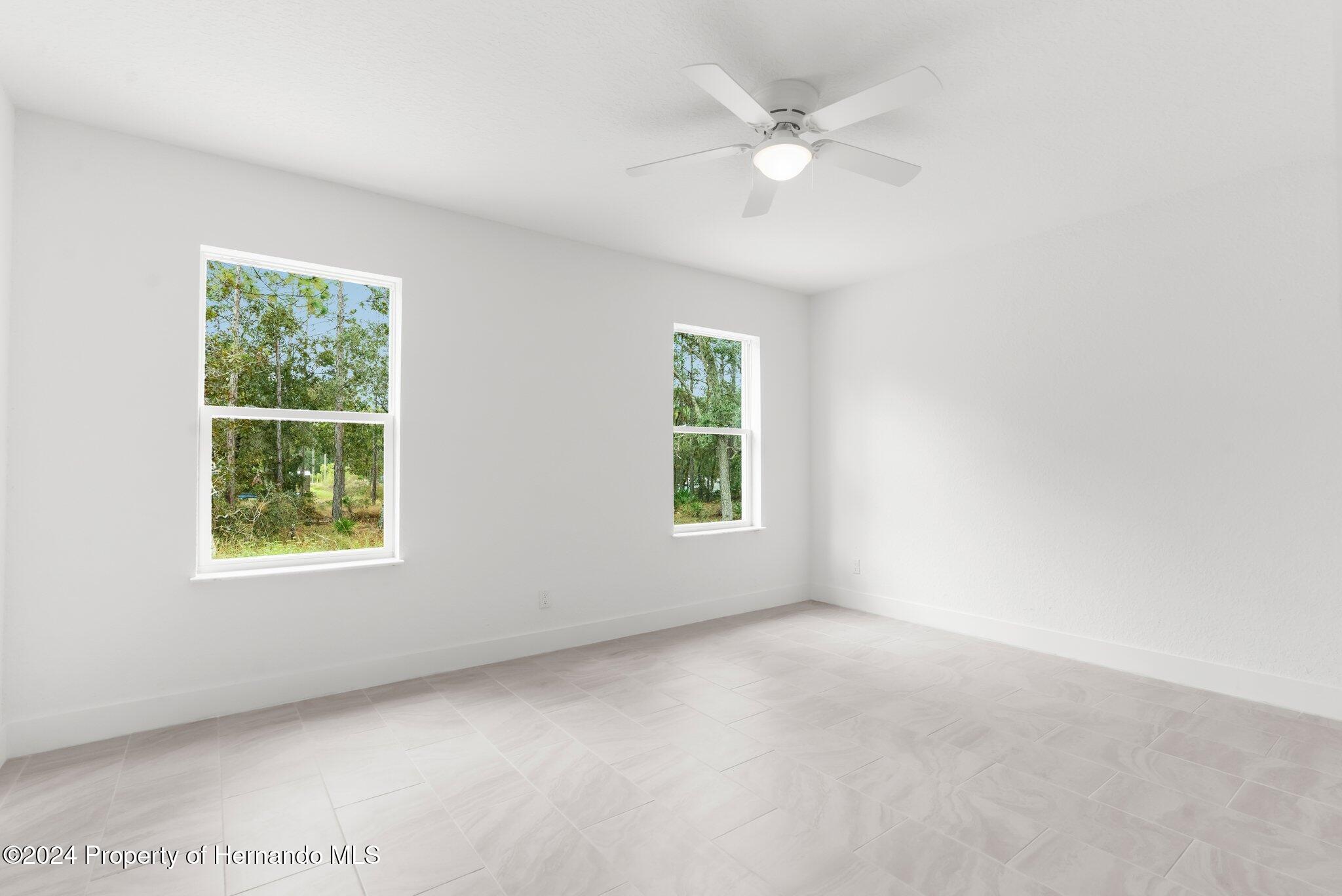 15214 Mt Sparrow Road Brooksville, FL 34614 - Photo 25 of 36 an empty room with a window
