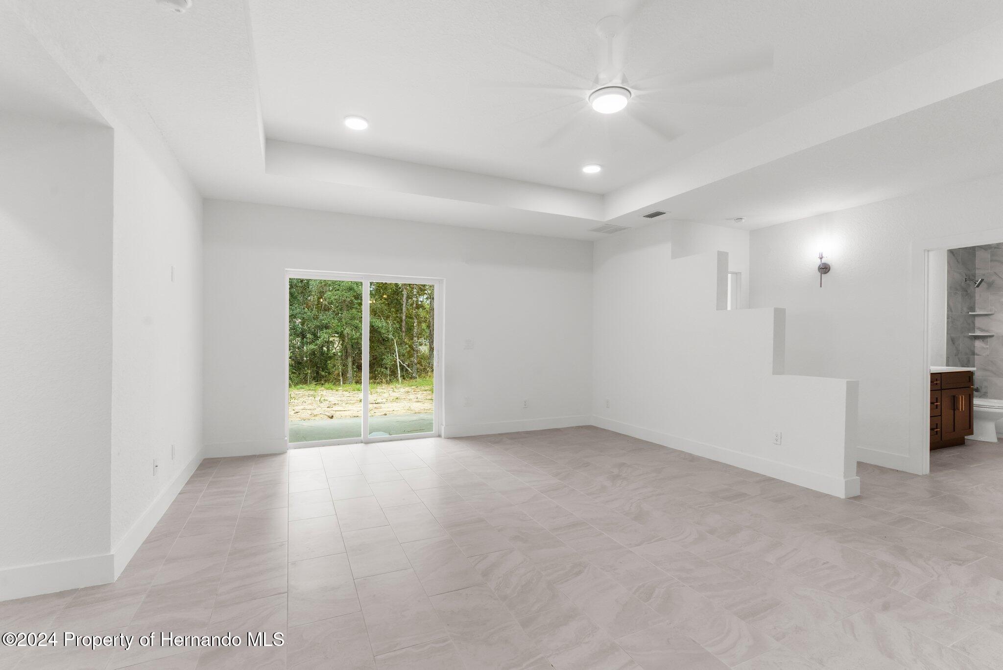 15214 Mt Sparrow Road Brooksville, FL 34614 - Photo 28 of 36 an empty room with a empty space and windows