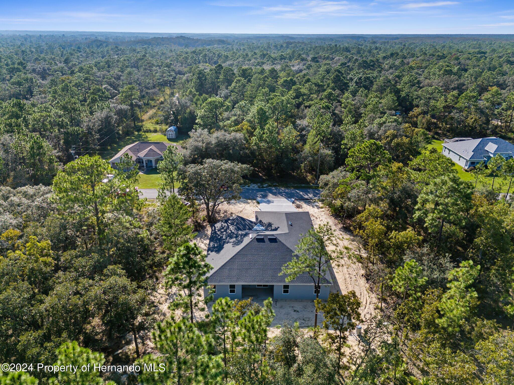 15214 Mt Sparrow Road Brooksville, FL 34614 - Photo 30 of 36 an aerial view of houses with yard