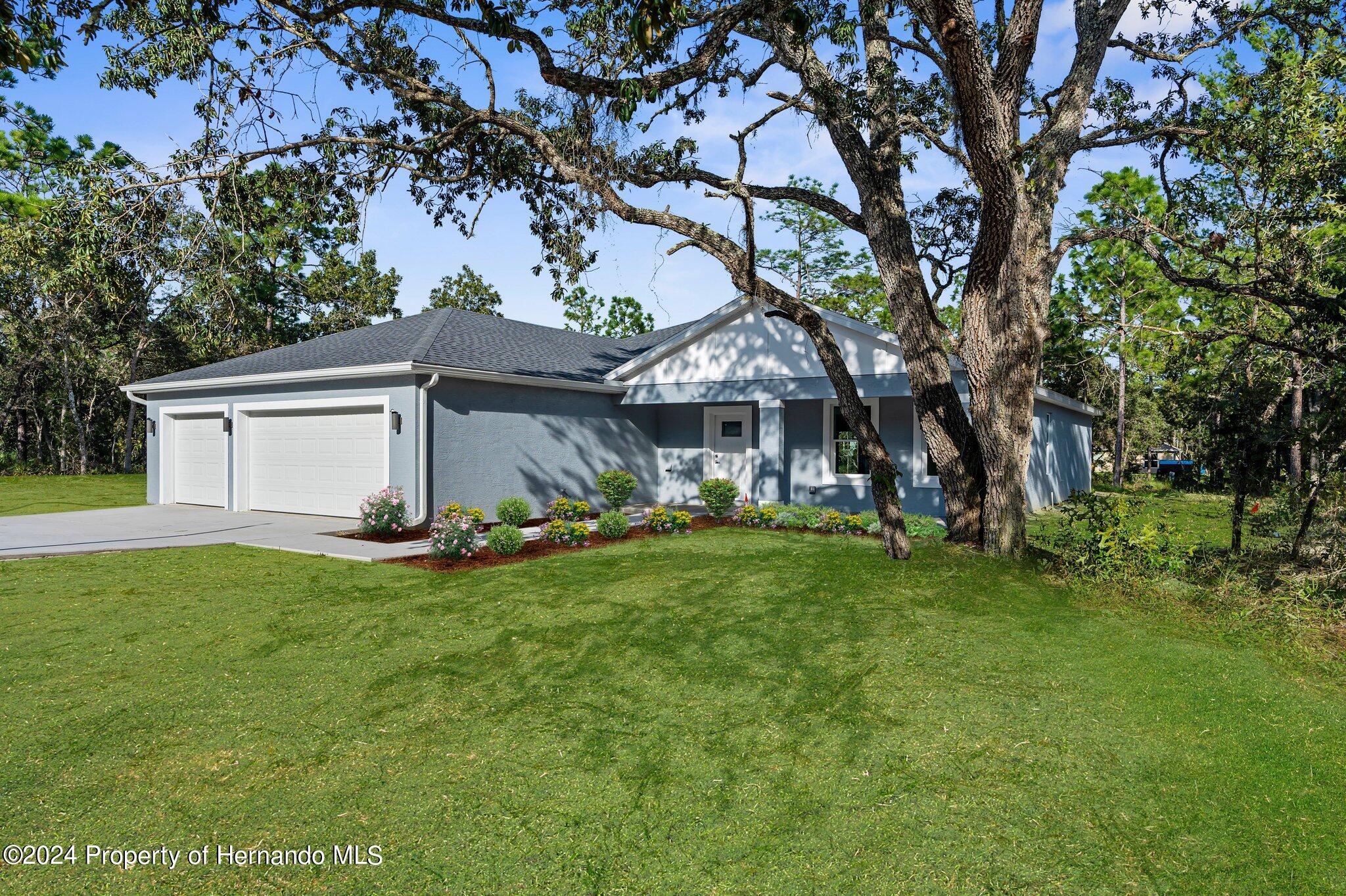 15214 Mt Sparrow Road Brooksville, FL 34614 - Photo 34 of 36 a view of a house with a backyard