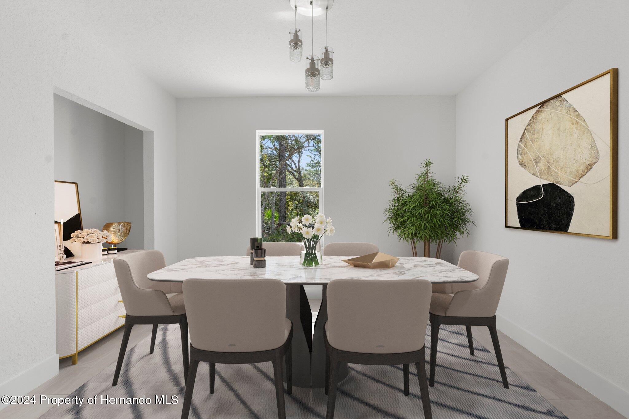 15214 Mt Sparrow Road Brooksville, FL 34614 - Photo 6 of 36 a view of a dining room with a table and chairs