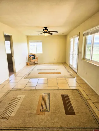 a view of a room with wooden floor and windows