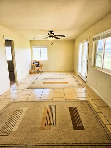 a view of a room with wooden floor and windows