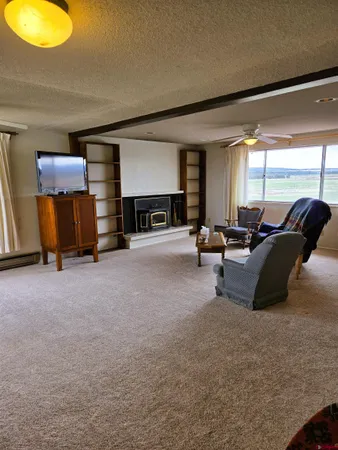 a bedroom with a bed dresser and a flat tv screen on a dresser