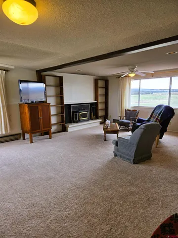 a bedroom with a bed dresser and a flat tv screen on a dresser