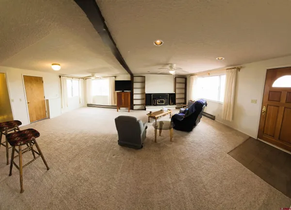 a living room with furniture and a large window