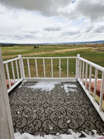 a view of a balcony with wooden fence