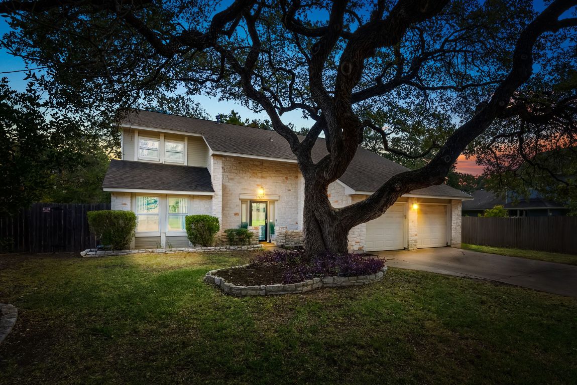 a front view of house with yard and green space