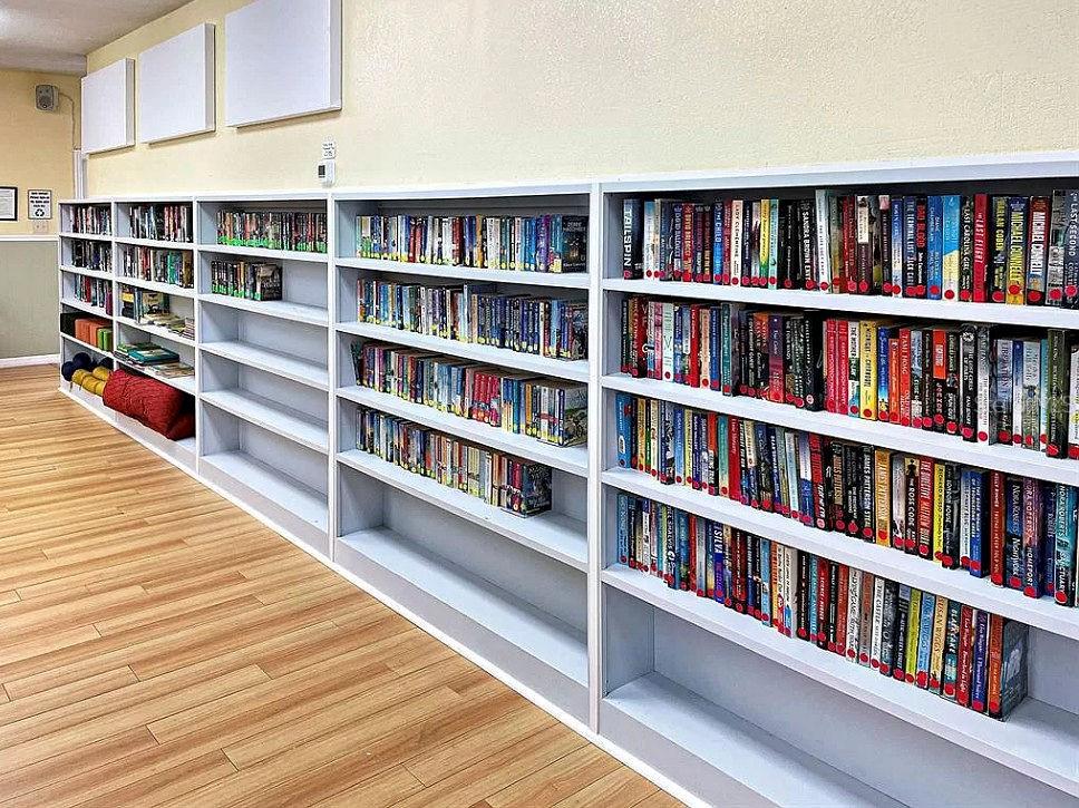 6000 Teahouse Road Venice, FL 34293 - Photo 6 of 13 a room with furniture and a book shelf