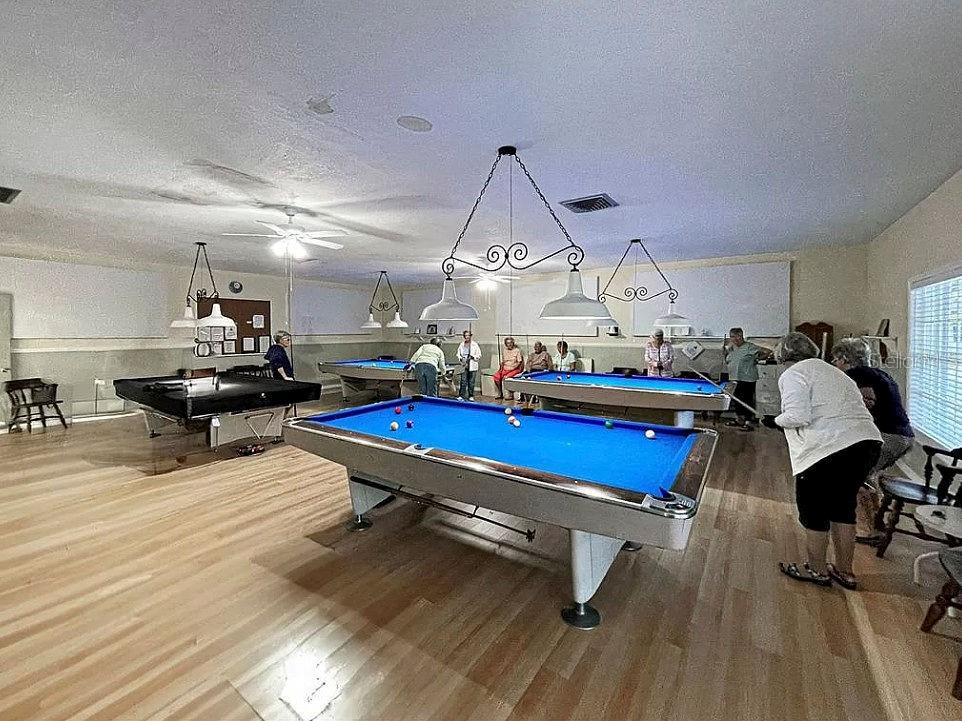 6000 Teahouse Road Venice, FL 34293 - Photo 7 of 13 a room with lots of gym equipment and wooden floor