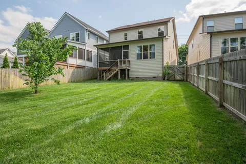 a view of a house with a yard and sitting area