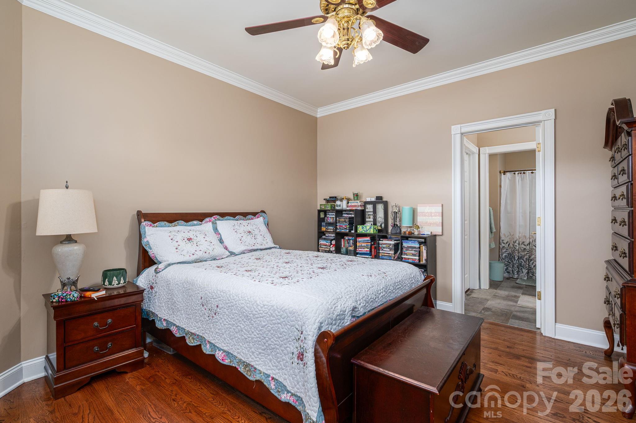 109 Wright Road Kings Mountain, NC 28086 - Photo 19 of 36 a bedroom with a bed and a chandelier