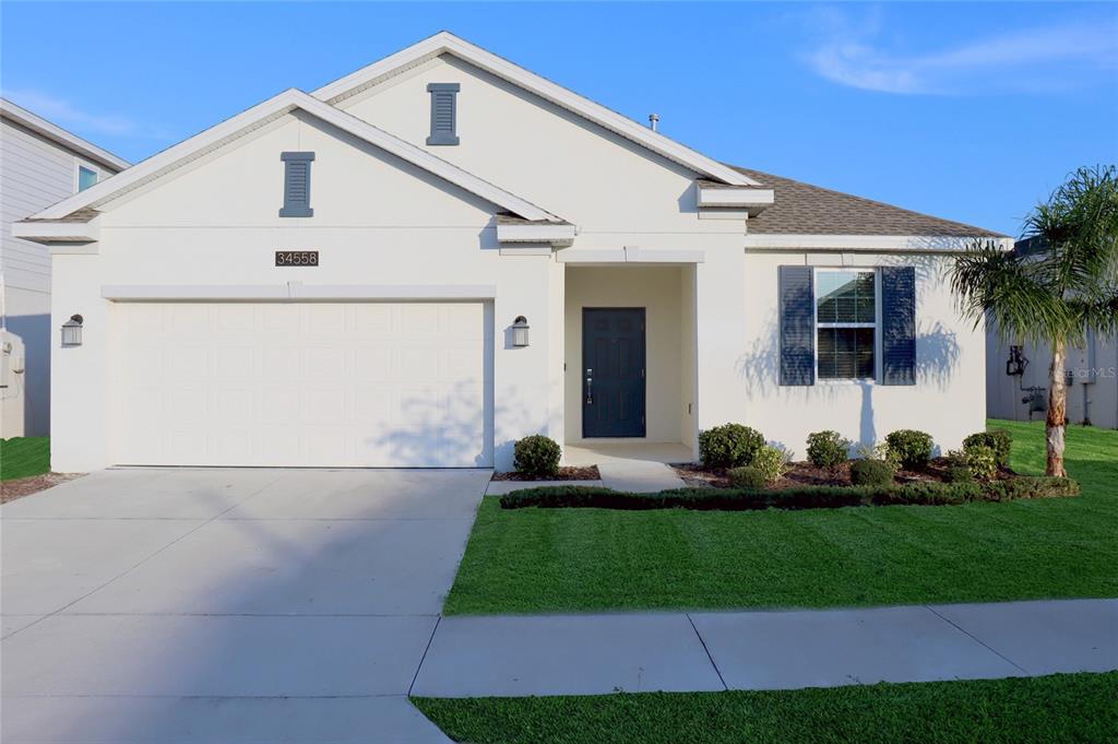 a front view of a house with a yard and garage
